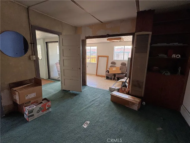 a living room with furniture a fireplace and a window