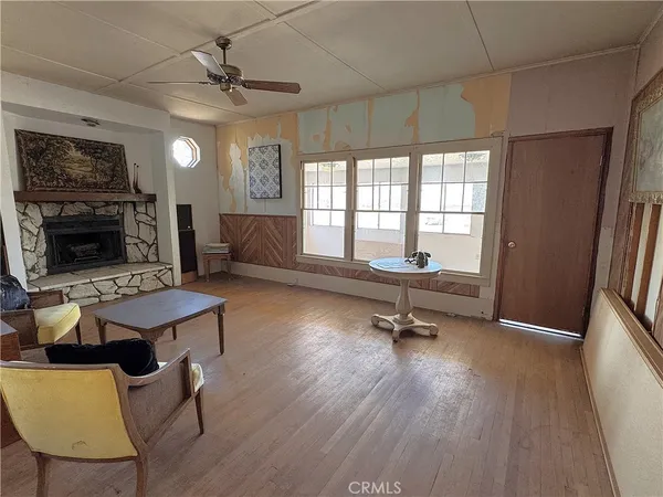 a view of living room filled with furniture and a window