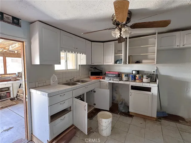 a kitchen with stainless steel appliances a stove a sink and a refrigerator