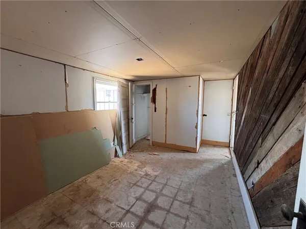 a living room with furniture a window and a flat screen tv