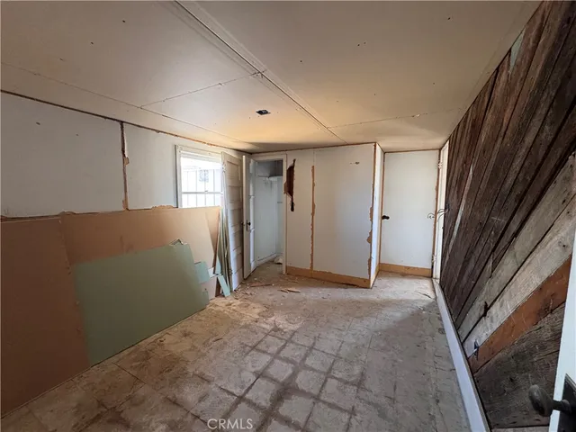 a living room with furniture a window and a flat screen tv