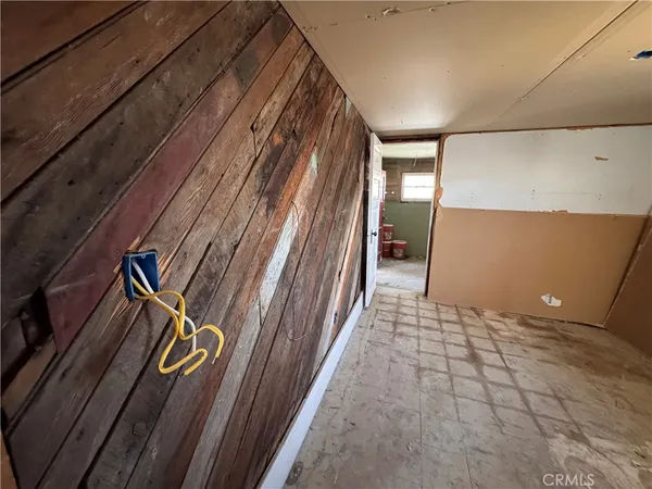 a view of a yard with wooden fence