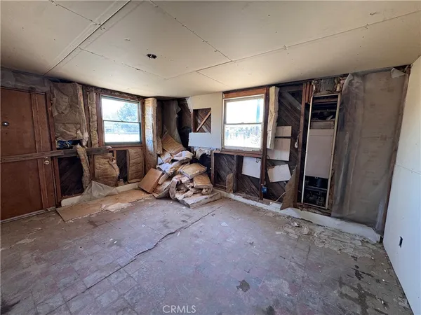 a backyard of a house with barbeque oven table and chairs
