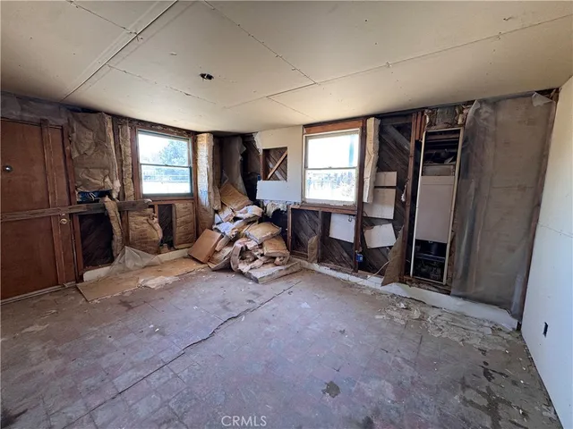a backyard of a house with barbeque oven table and chairs