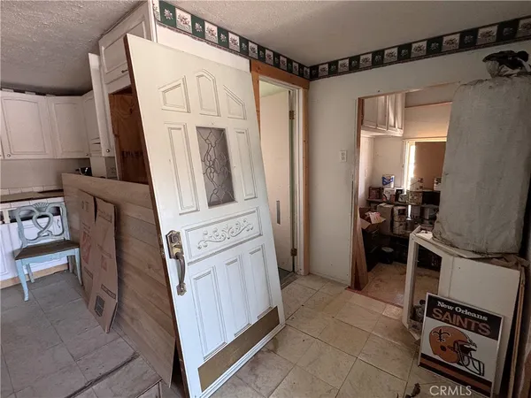 a kitchen with white cabinets and white appliances