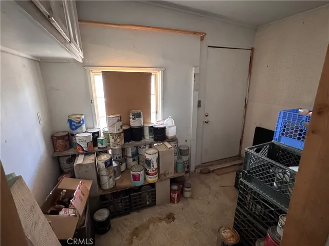 a living room with furniture kitchen view and a flat screen tv