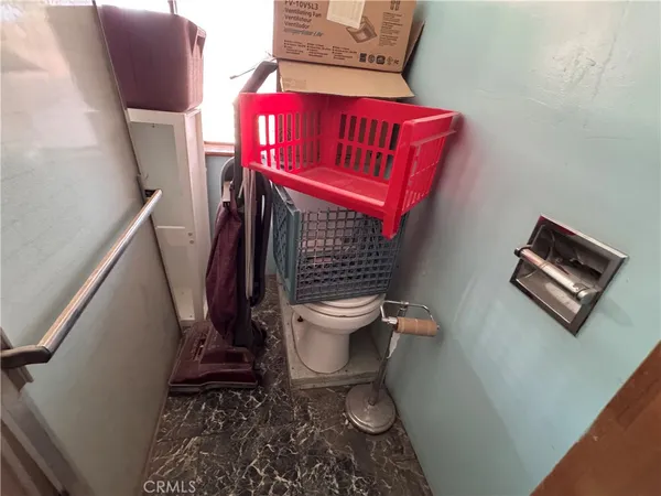 a bathroom with a toilet sink and mirror