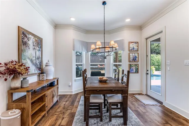 a kitchen with stainless steel appliances granite countertop a sink a stove and a wooden floors