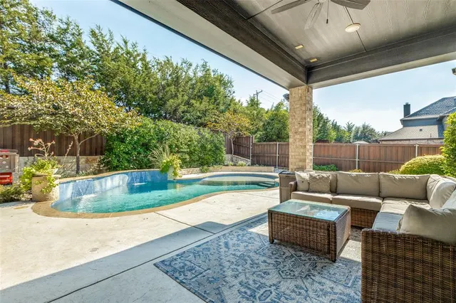a view of a house with backyard sitting area and garden