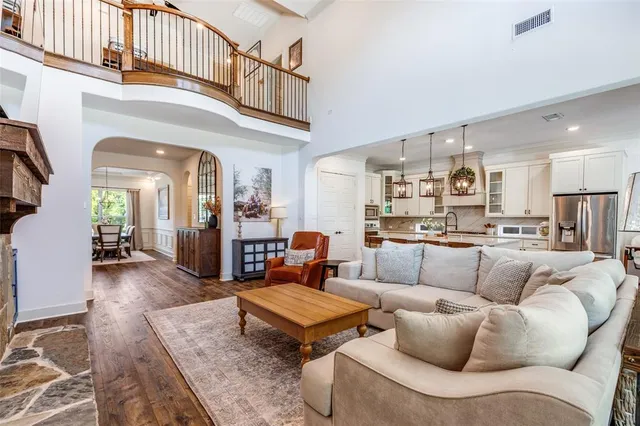 a living room with furniture a rug and a kitchen view