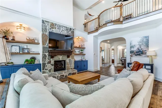 a living room with furniture a flat screen tv and a fireplace