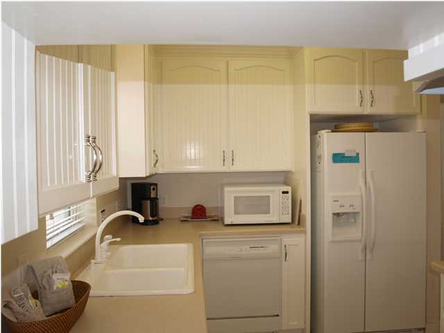 60 Brown Street Santa Rosa Beach, FL 32459 - Photo 5 of 17 a kitchen with stainless steel appliances cabinets and a window