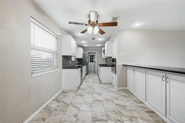 a view of a kitchen with a sink and a refrigerator