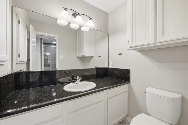 a view of a room with wooden floor and a bathroom