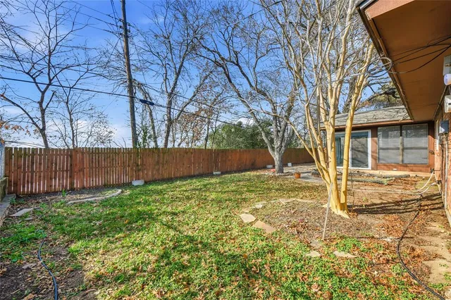 a view of a house with large windows and a tree