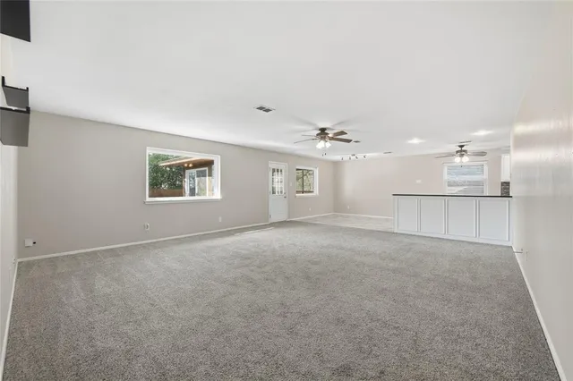 an empty room with a empty space and windows