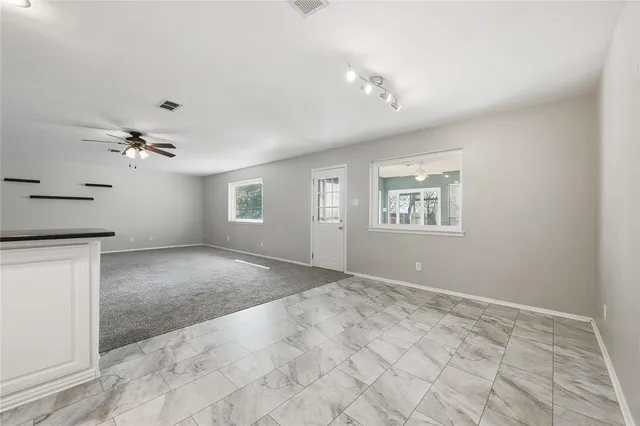 a view of a kitchen with kitchen island wooden floor center island and stainless steel appliances