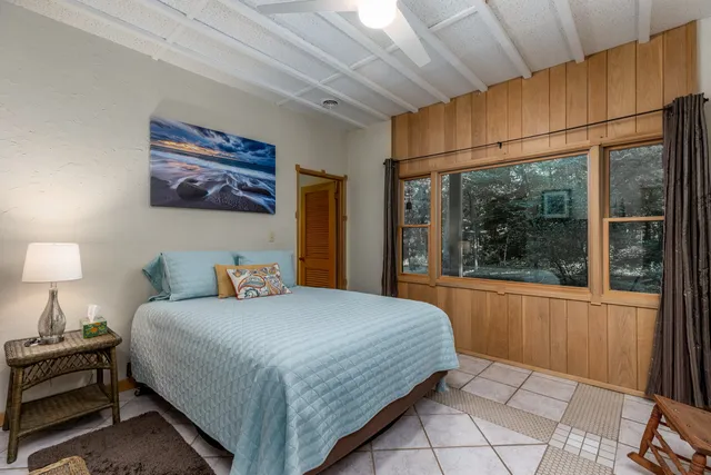 a bathroom with a sink a toilet and shower a mirror