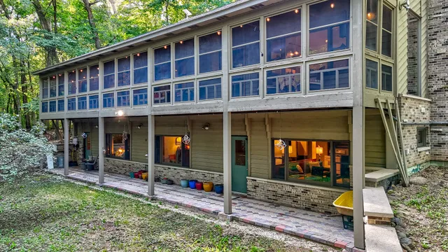 a view of a house with backyard and porch
