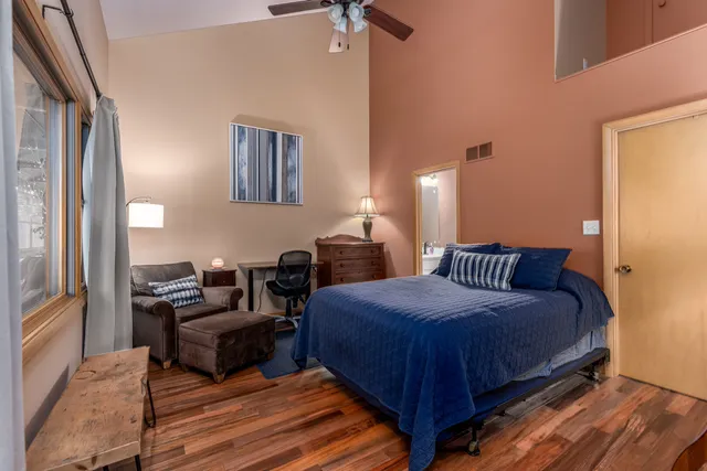 a bedroom with bed and a chandelier