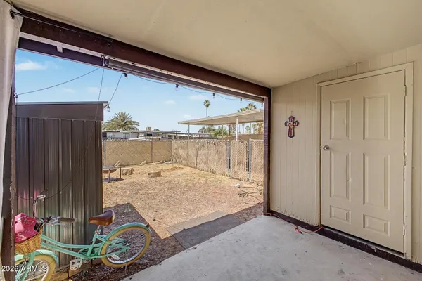 a backyard of a house with table and chairs