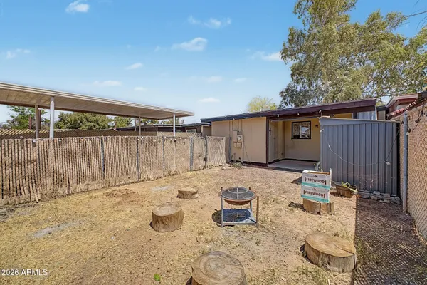 a view of a house with backyard and sitting area