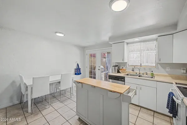 a kitchen with a sink dishwasher stove and refrigerator