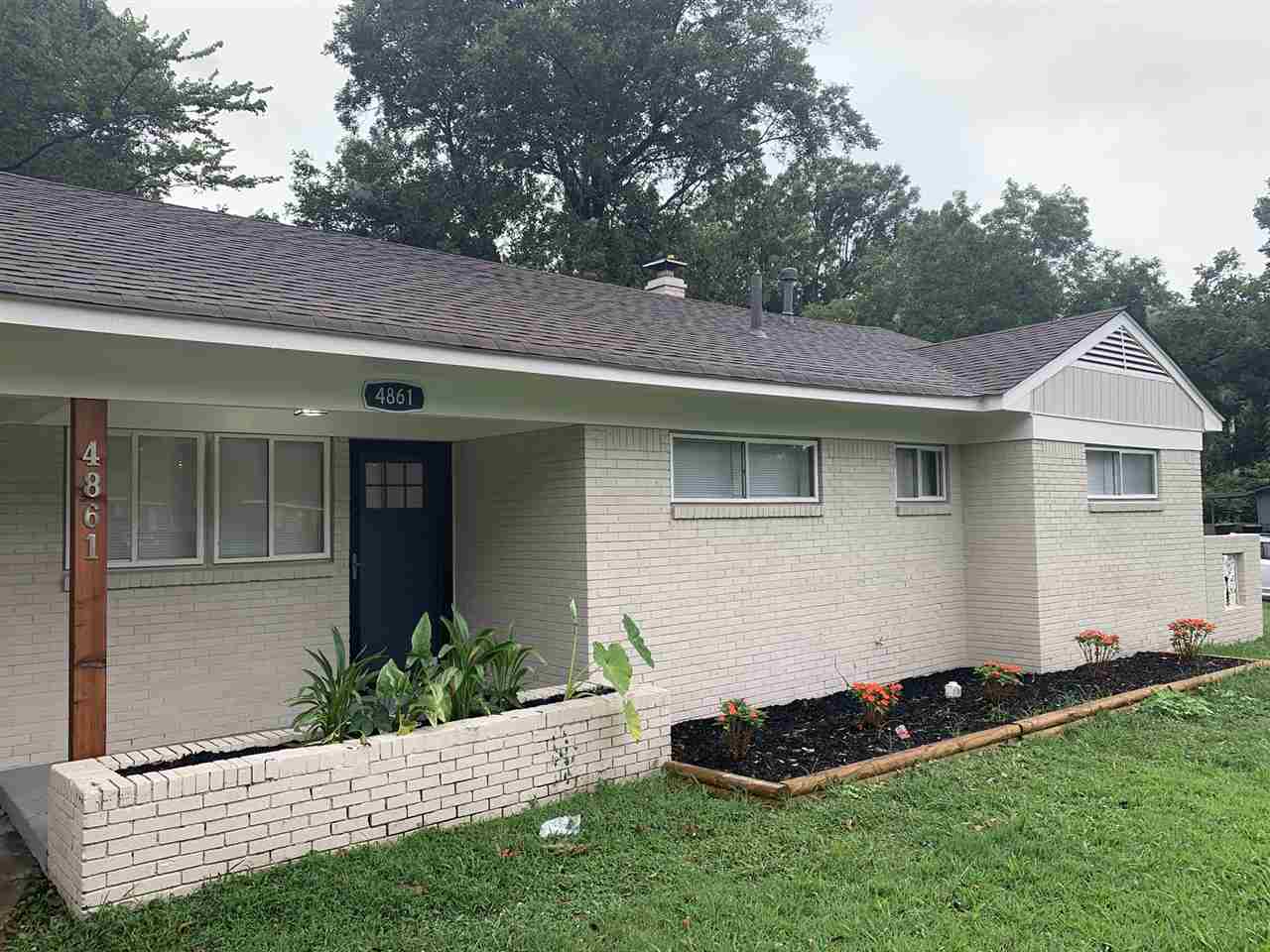 4861 Quince Road Memphis, TN 38117 - Photo 2 of 14 Updated exterior with light taupe paint, wood beams and cute planters lining the front of the home!