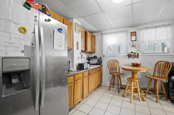 a large kitchen with a table and chairs