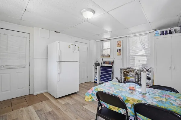 a kitchen with a table chairs and a refrigerator
