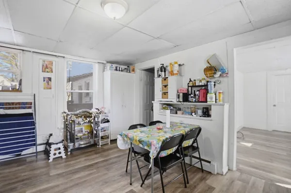 a dining room with furniture and wooden floor