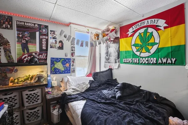 a bed sitting in a bedroom next to a window