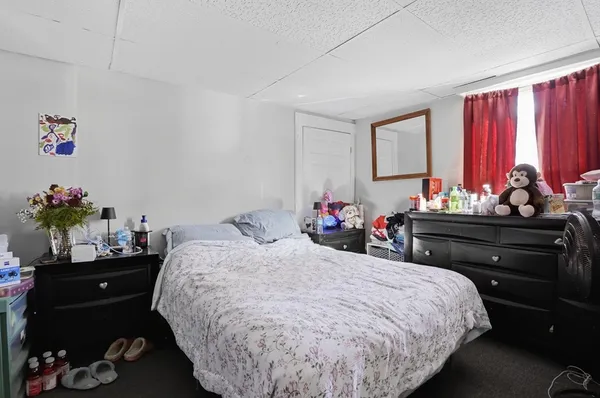 a bedroom with a bed and a dresser