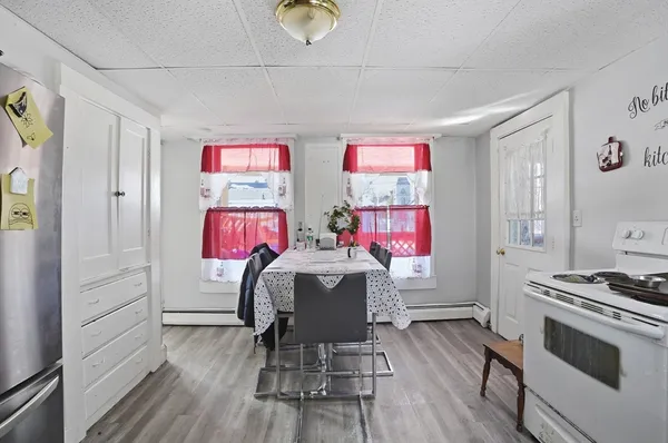 a very nice looking room with wooden floor and furniture