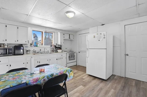 a kitchen with stainless steel appliances a refrigerator sink and white cabinets