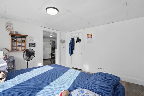 a bedroom with a bed and a mirror