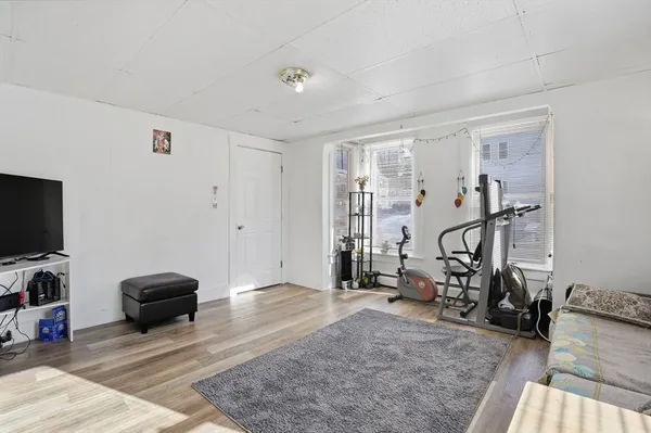 a view of a livingroom with gym equipment