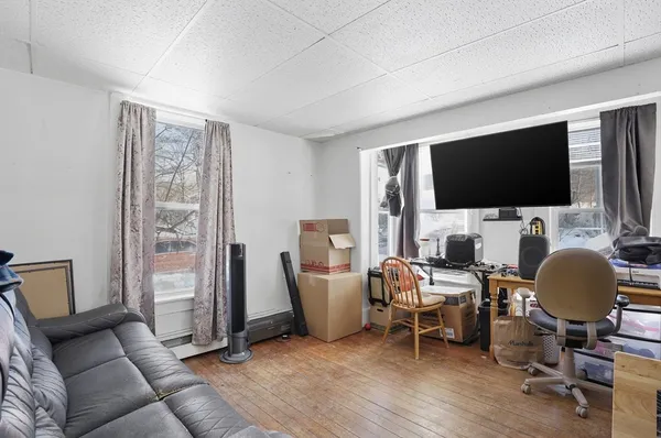 a view of a livingroom with workspace and a window