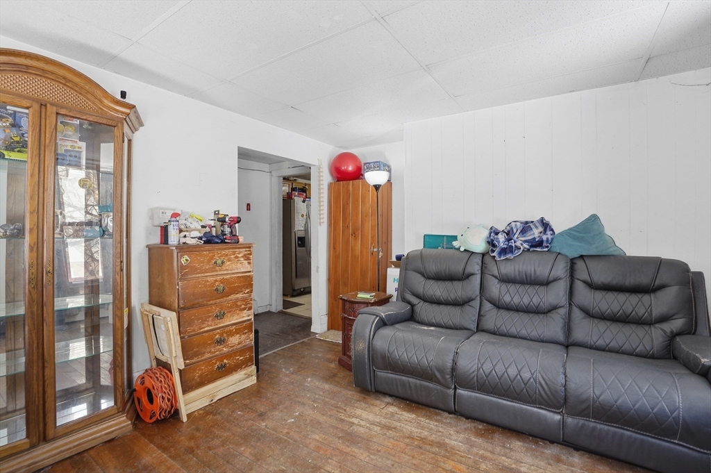 52-56 Green Street Athol, MA 01331 - Photo 8 of 41 a living room with furniture a refrigerator and a flat screen tv