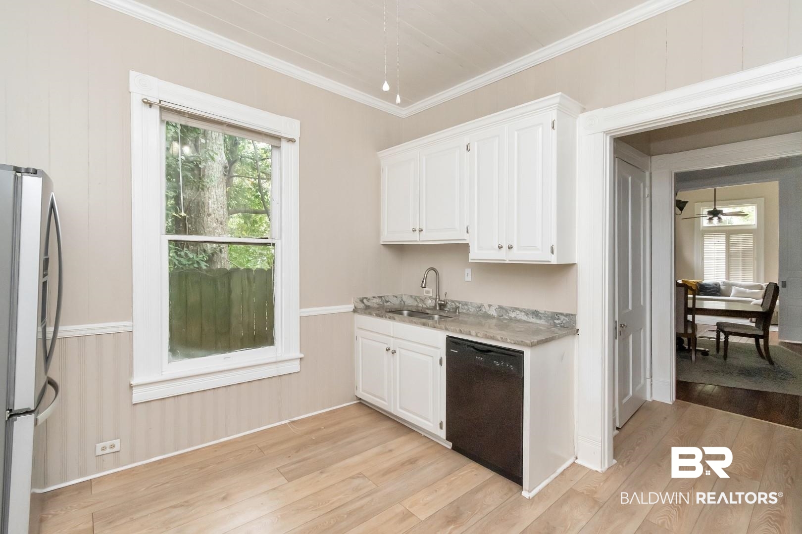 1305 Brown Street Mobile, AL 36604 - Photo 13 of 37 Kitchen with black dishwasher, refrigerator, crown molding, white cabinetry, and light hardwood / wood-style floors