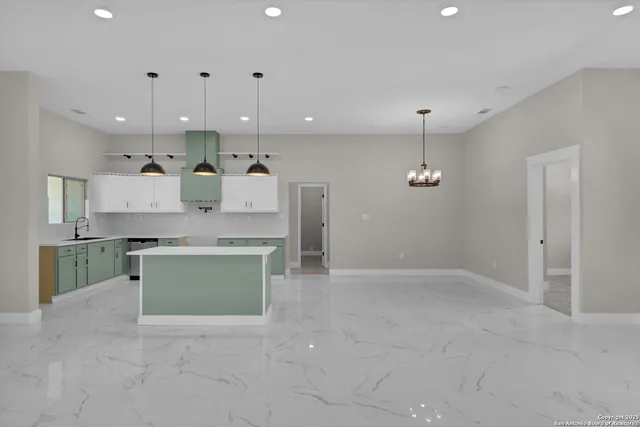 a large kitchen with cabinets stove and refrigerator