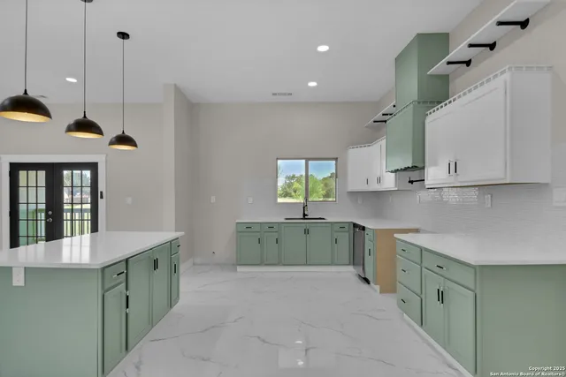 a kitchen with a sink stove and cabinets
