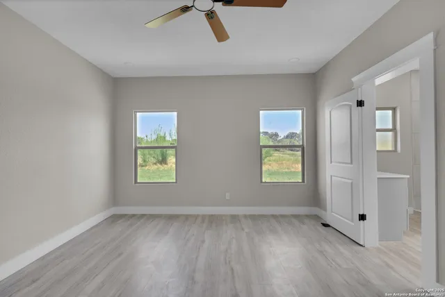 a view of room with window and ceiling fan