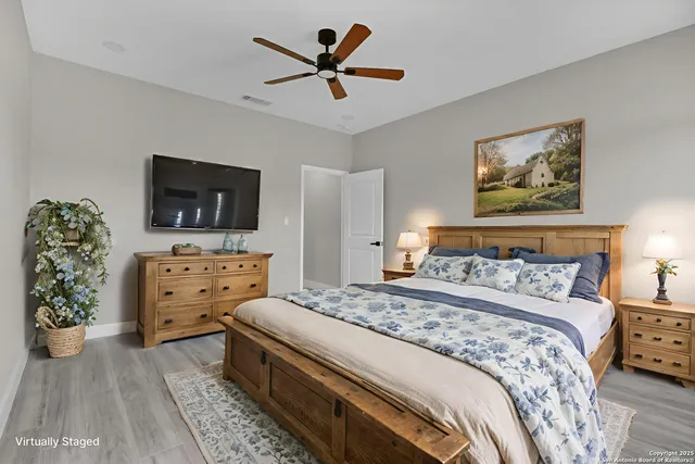 a bedroom with a bed and a flat screen tv