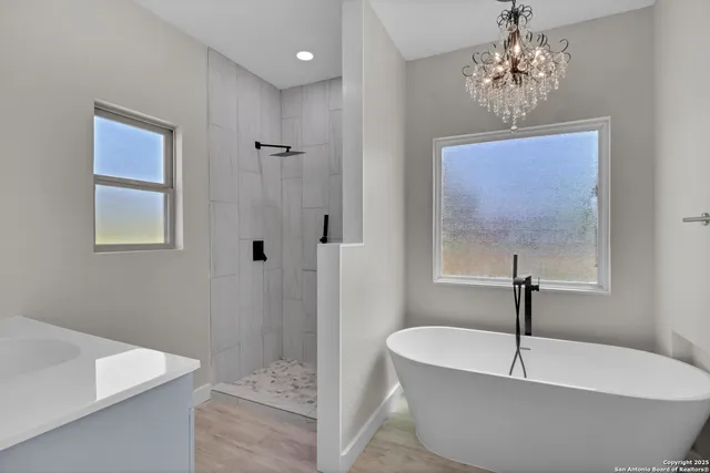 a bathroom with a white tub sitting next to a window