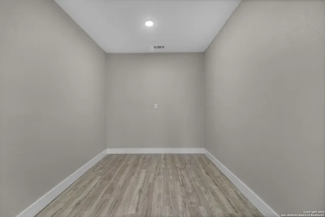 a view of room with wooden floor