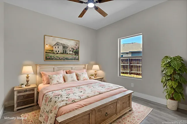 a bedroom with a bed and a potted plant