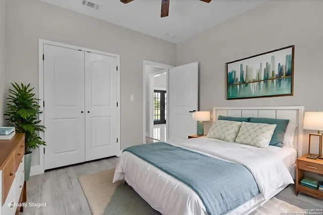 a bedroom with a bed and a painting on the wall