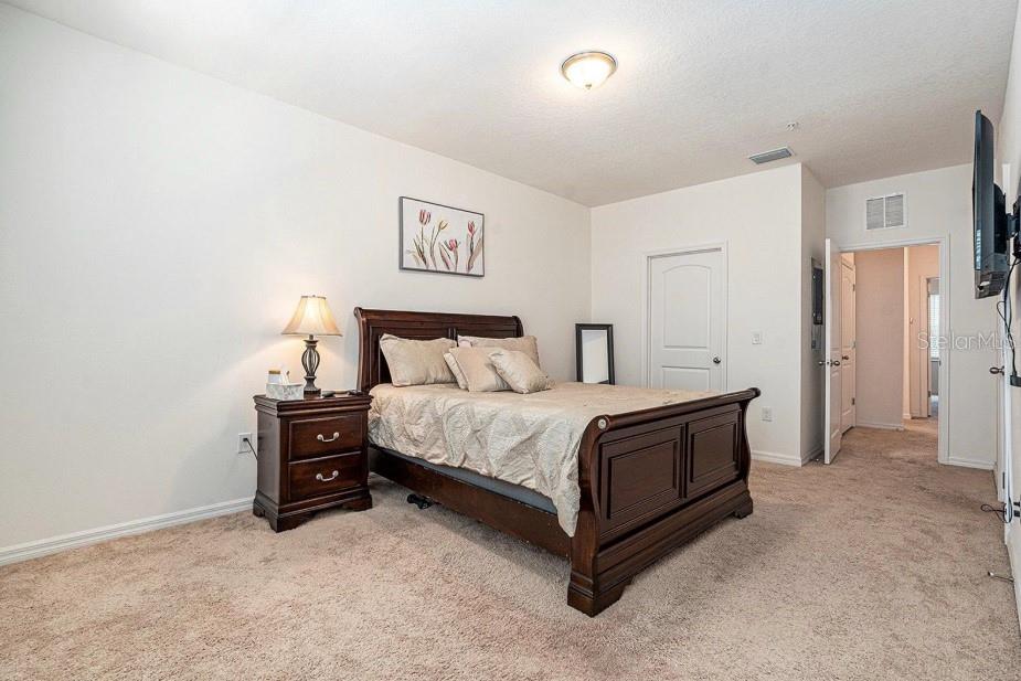 5521 Yellowfin Court New Port Richey, FL 34652 - Photo 10 of 23 a bedroom with a bed and a table