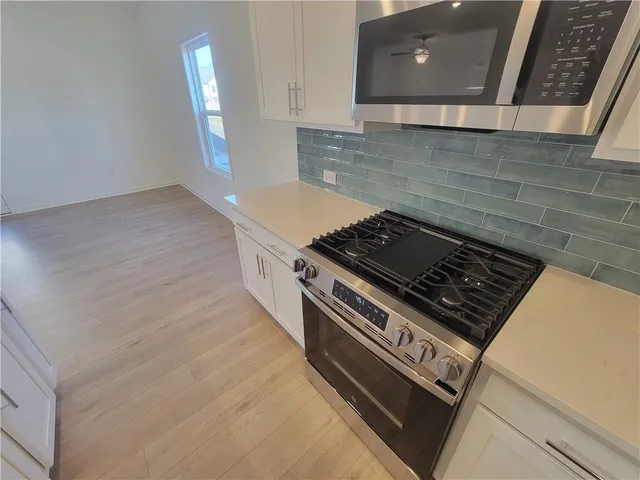 a stove top oven sitting inside of a kitchen